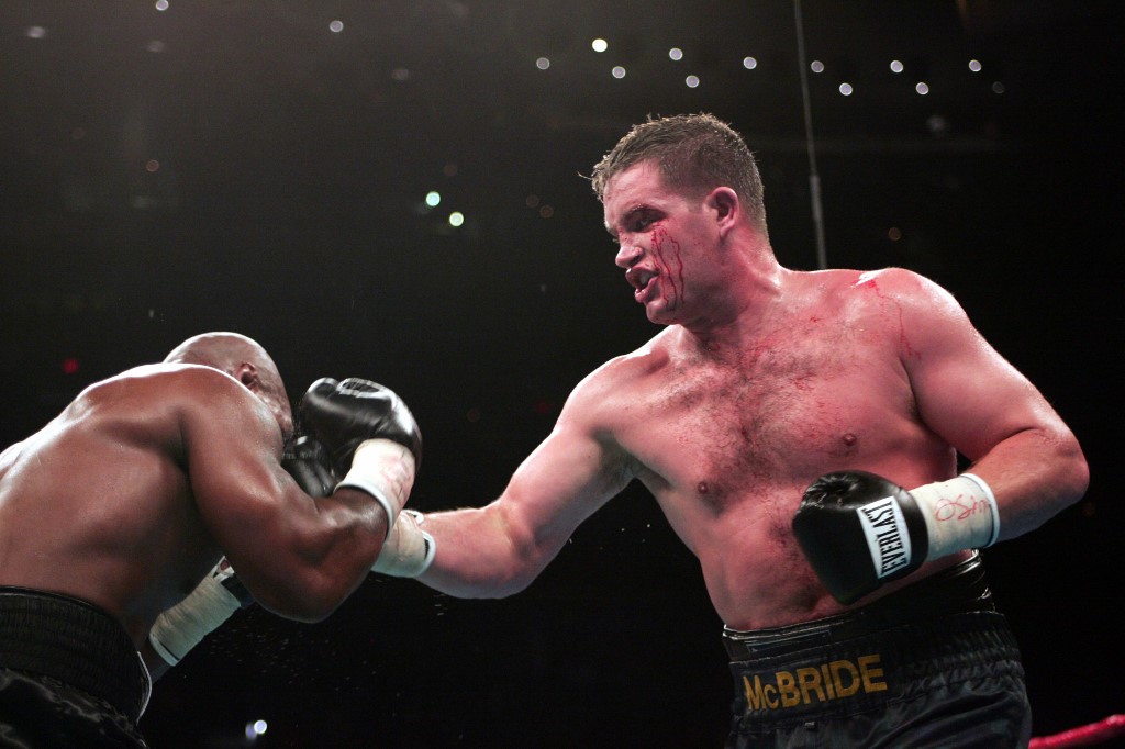 A bloodied Kevin McBride (R) of Ireland unloads against former heavyweight champion Mike Tyson (L) 11 June 2005 at the MCI Center in Washington, DC.  McBride was declared winner when Tyson quit after the sixth round. AFP PHOTO/Paul. J. RICHARDS (Photo by PAUL J. RICHARDS / AFP)